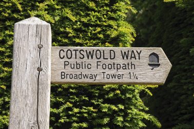 Wooden Cotswold Way signpost giving directions to Broadway Tower, Broadway, Cotswolds, Worcestershire, England, UK, Western Europe.